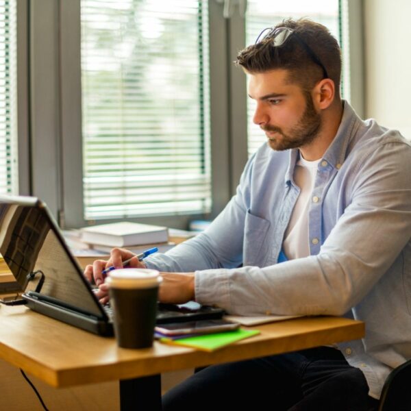 man typing on a laptop